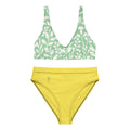 Haut de bikini vert à motif feuilles et bas taille haute jaune.