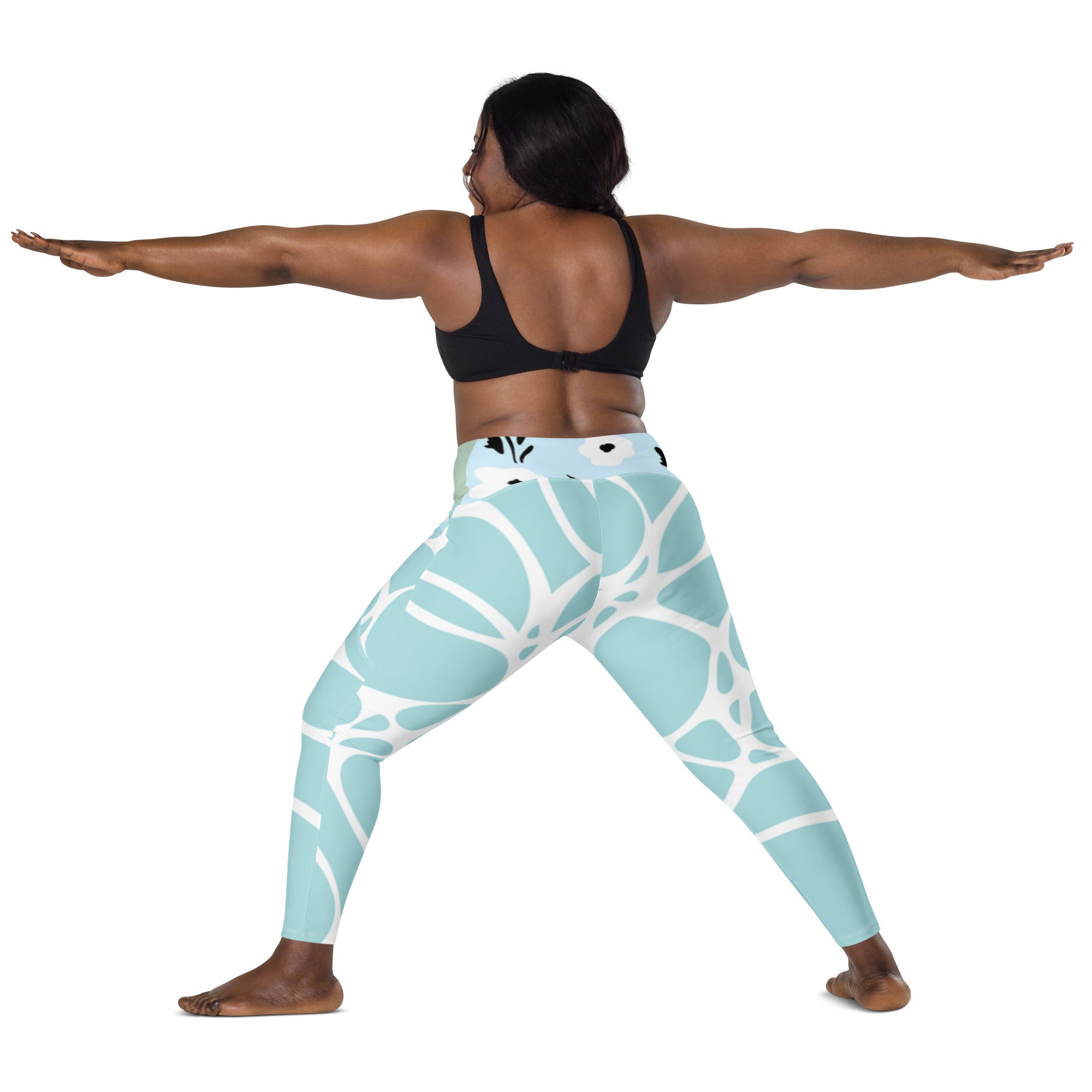 Leggings turquoise motif blanc, poches latérales, vue arrière en mouvement.