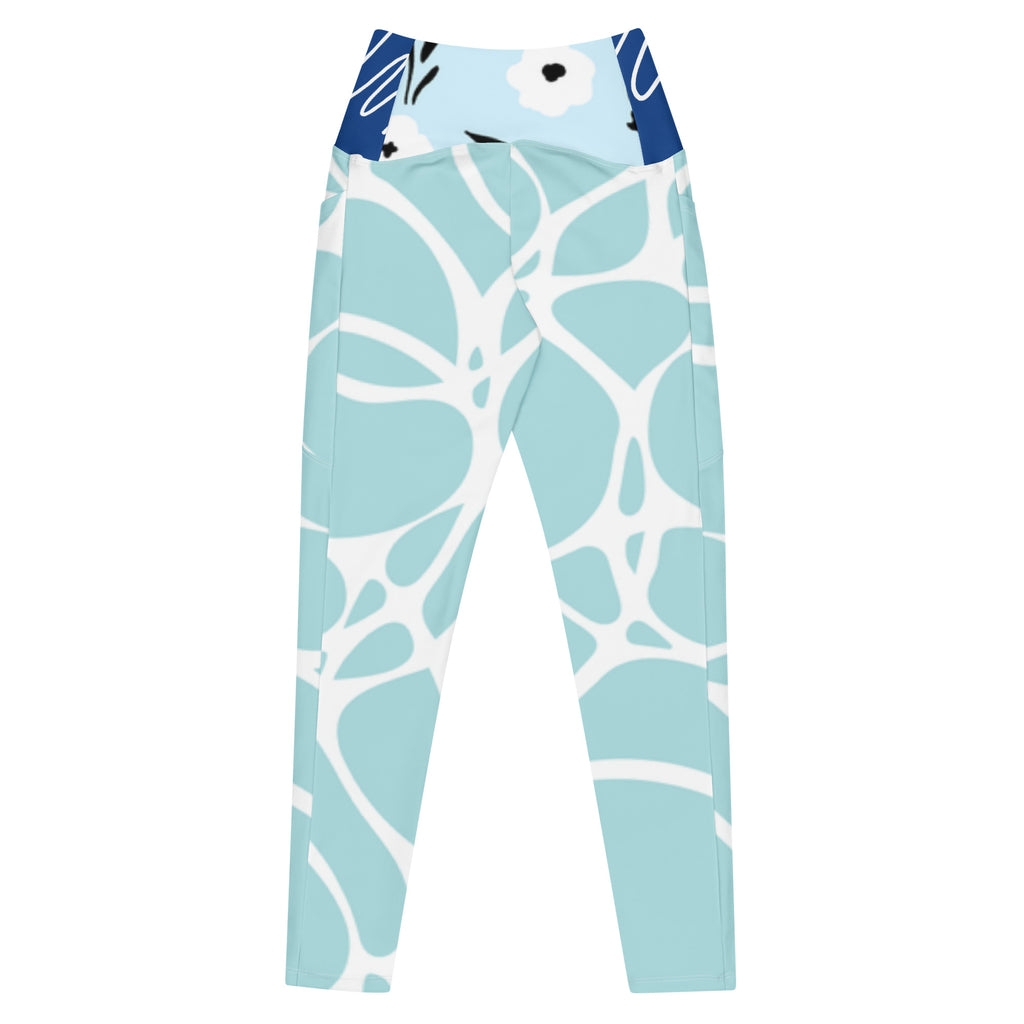 Leggings aqua motif feuilles blanches, bord bleu marine en haut, coupe près du corps.
