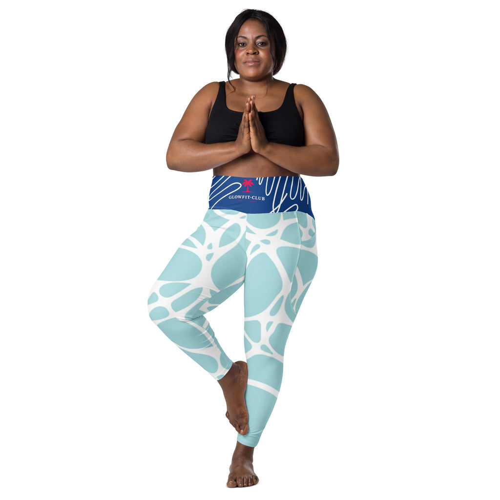 Leggings aqua motif feuilles blanches, taille haute, poches latérales, tissu extensible.