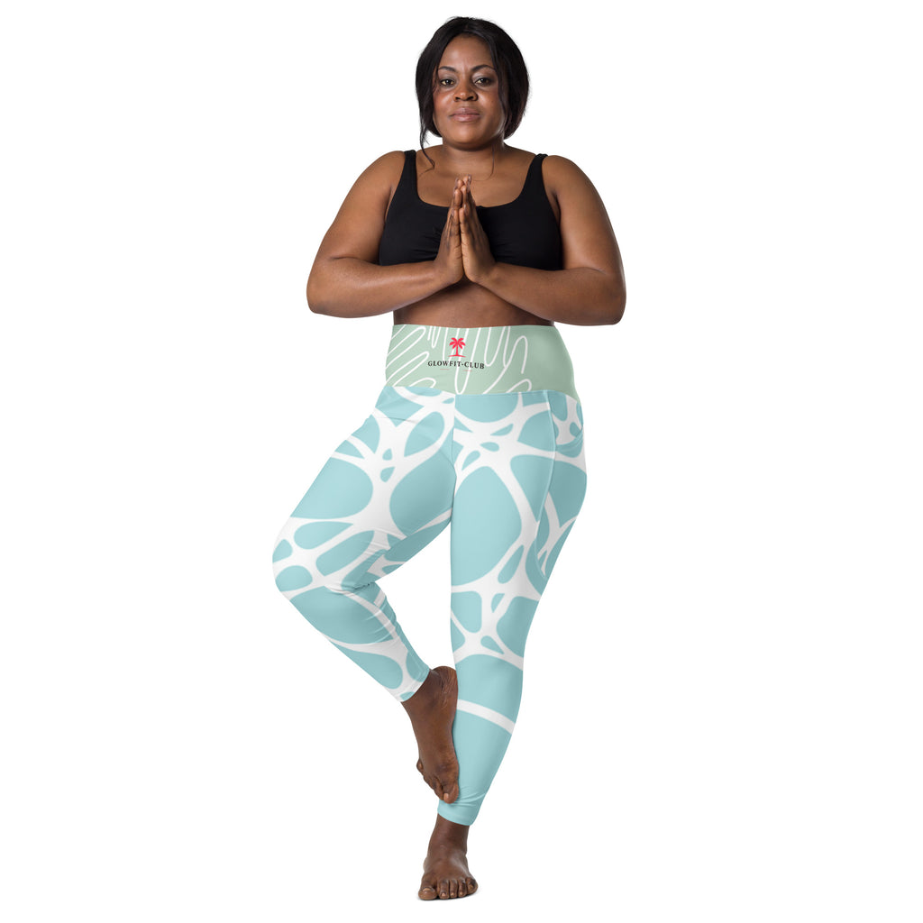 Leggings turquoise motif blanc, poches latérales, tenue près du corps.