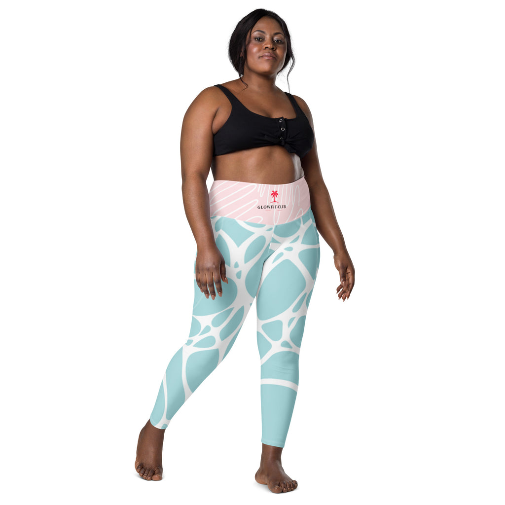 Leggings vert d’eau motif blanc, taille rose clair avec petit logo central.