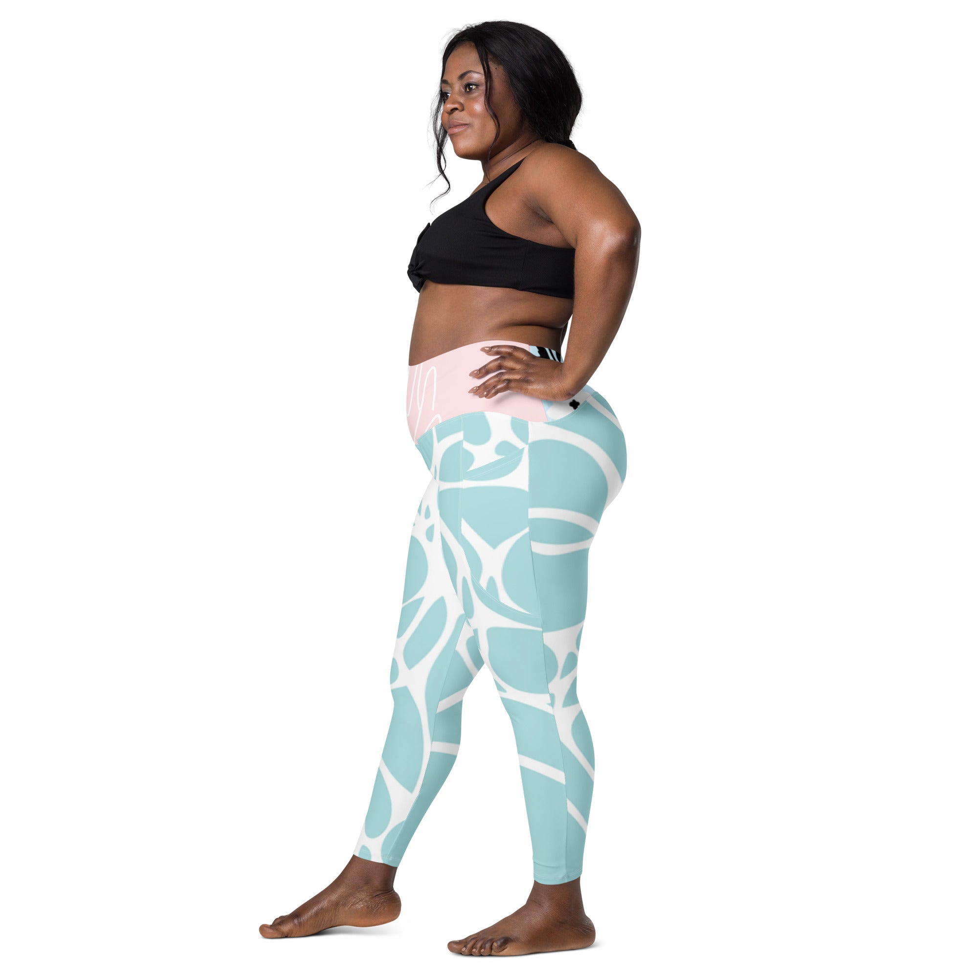 Leggings vert d’eau motif blanc, vue de côté, panneau de taille rose clair.