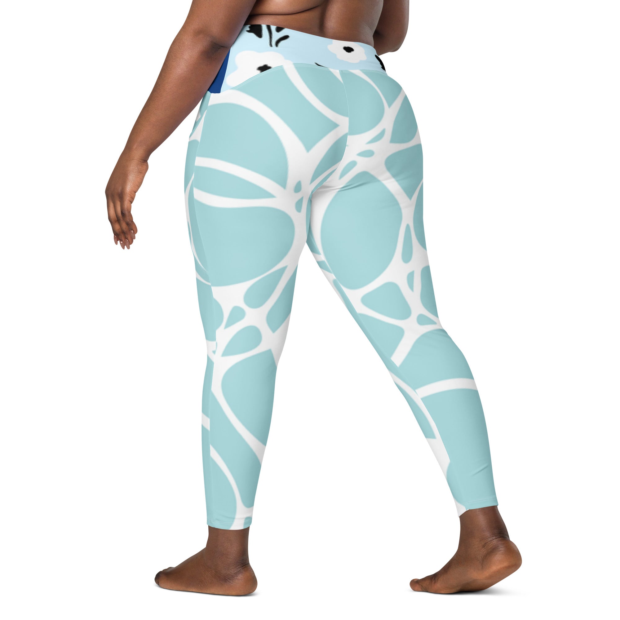Leggings turquoise à motif abstrait blanc, taille haute, jambes fuselées.