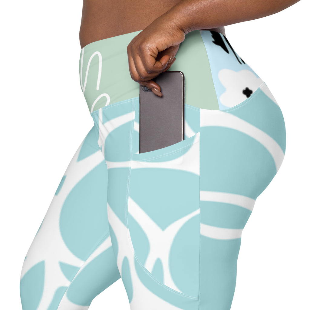 Leggings bleu aqua à poches latérales, motif blanc abstrait et rabat de poche.