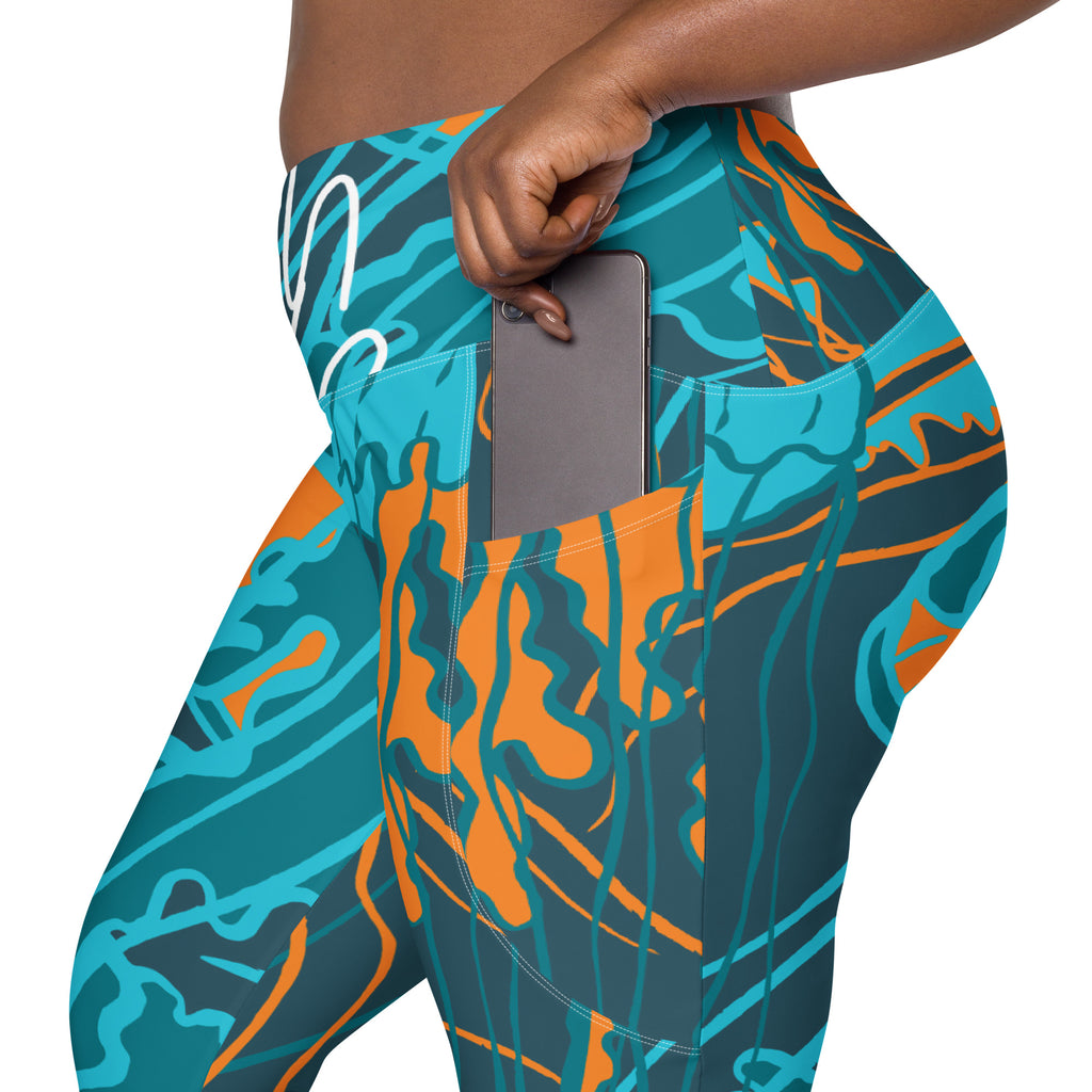 Legging à poches latérales, motif océan bleu-vert et orange, poche ouverte.