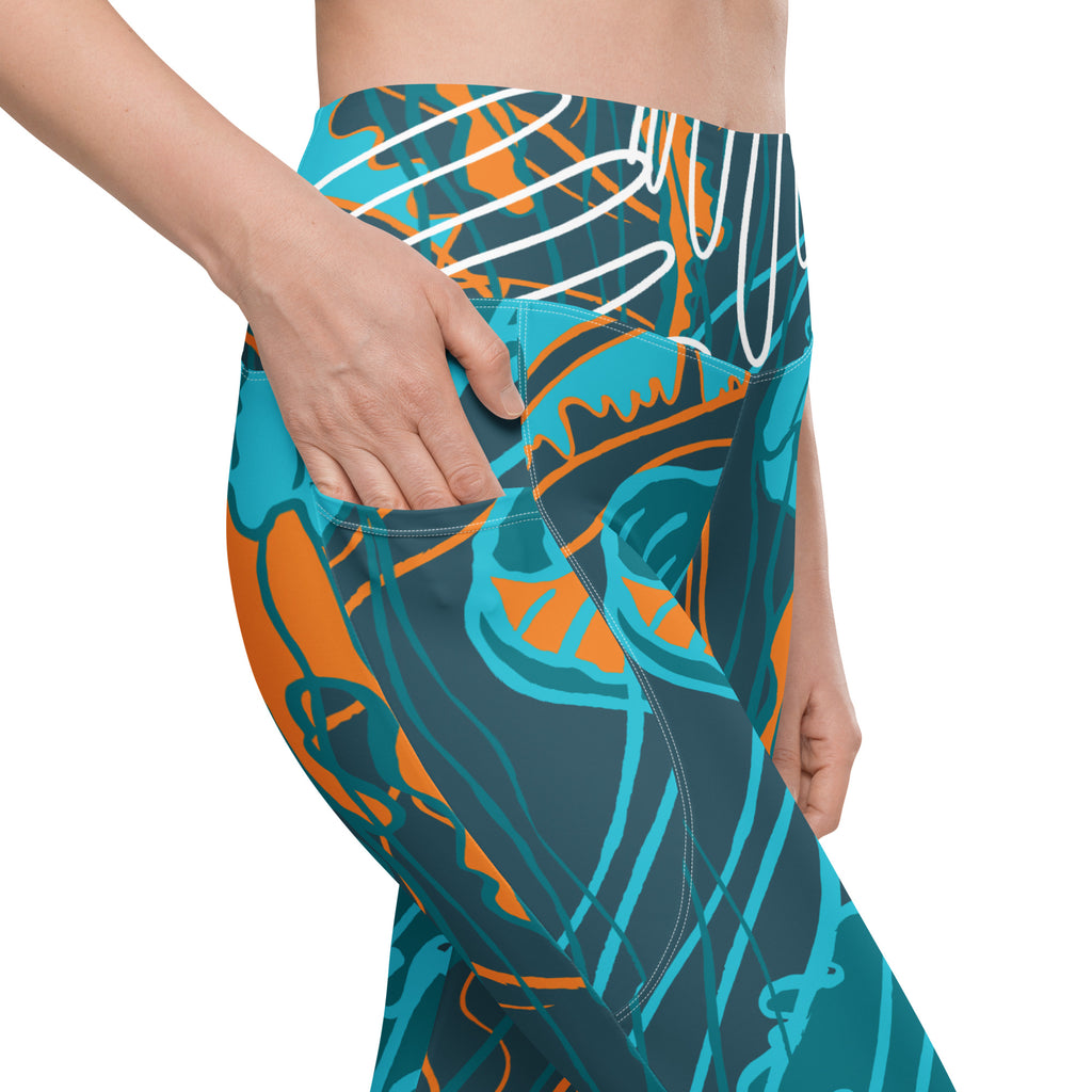 Legging motif océan bleu-vert et orange, poche latérale, coupe près du corps.