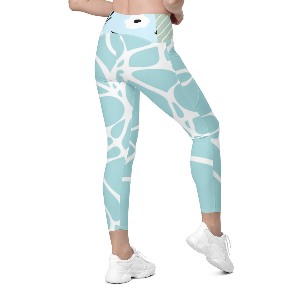 Leggings bleu aqua à motif blanc, poche latérale discrète, finition resserrée à la cheville.