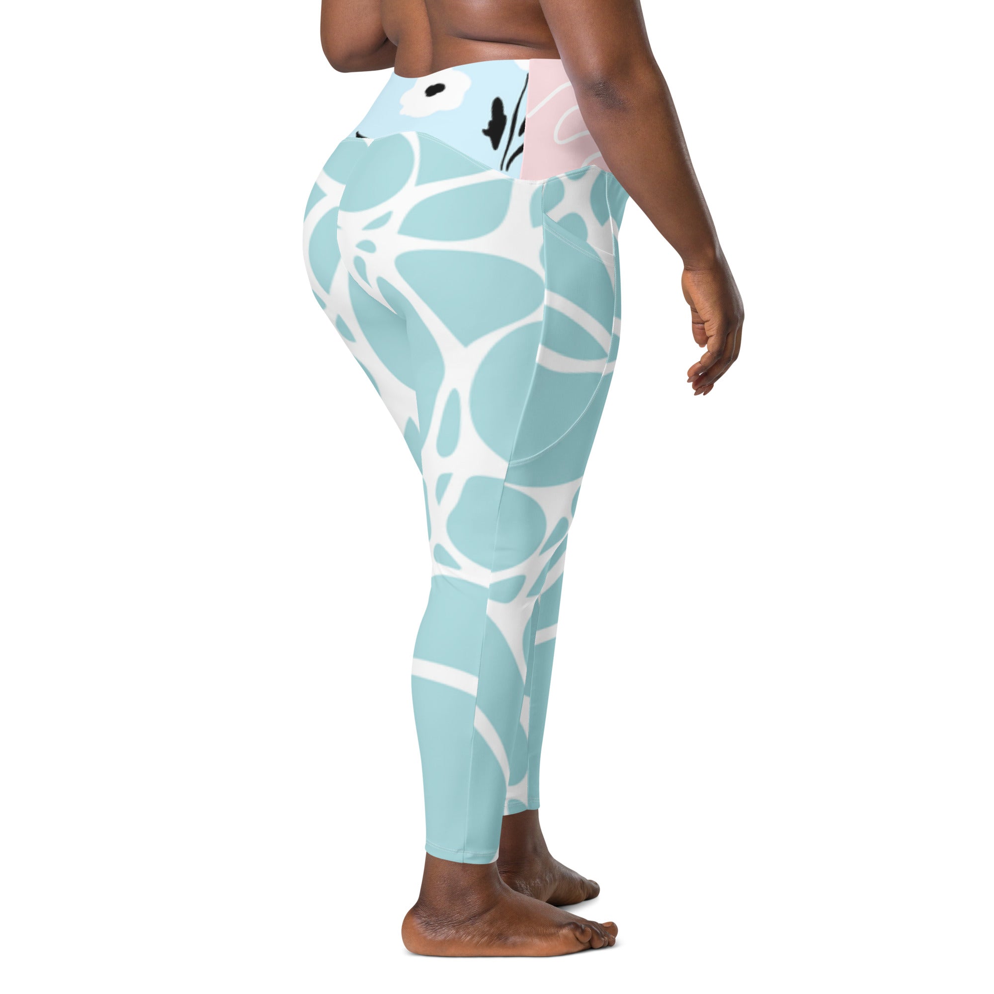 Leggings vert d’eau à motif blanc stylisé, vue de côté, taille rose clair.