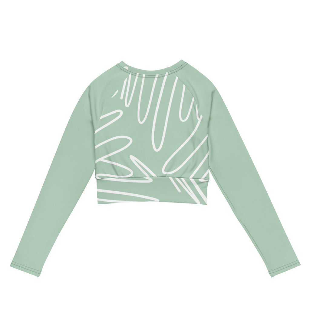 Haut court vert menthe à manches longues, imprimé blanc abstrait, présenté à plat.