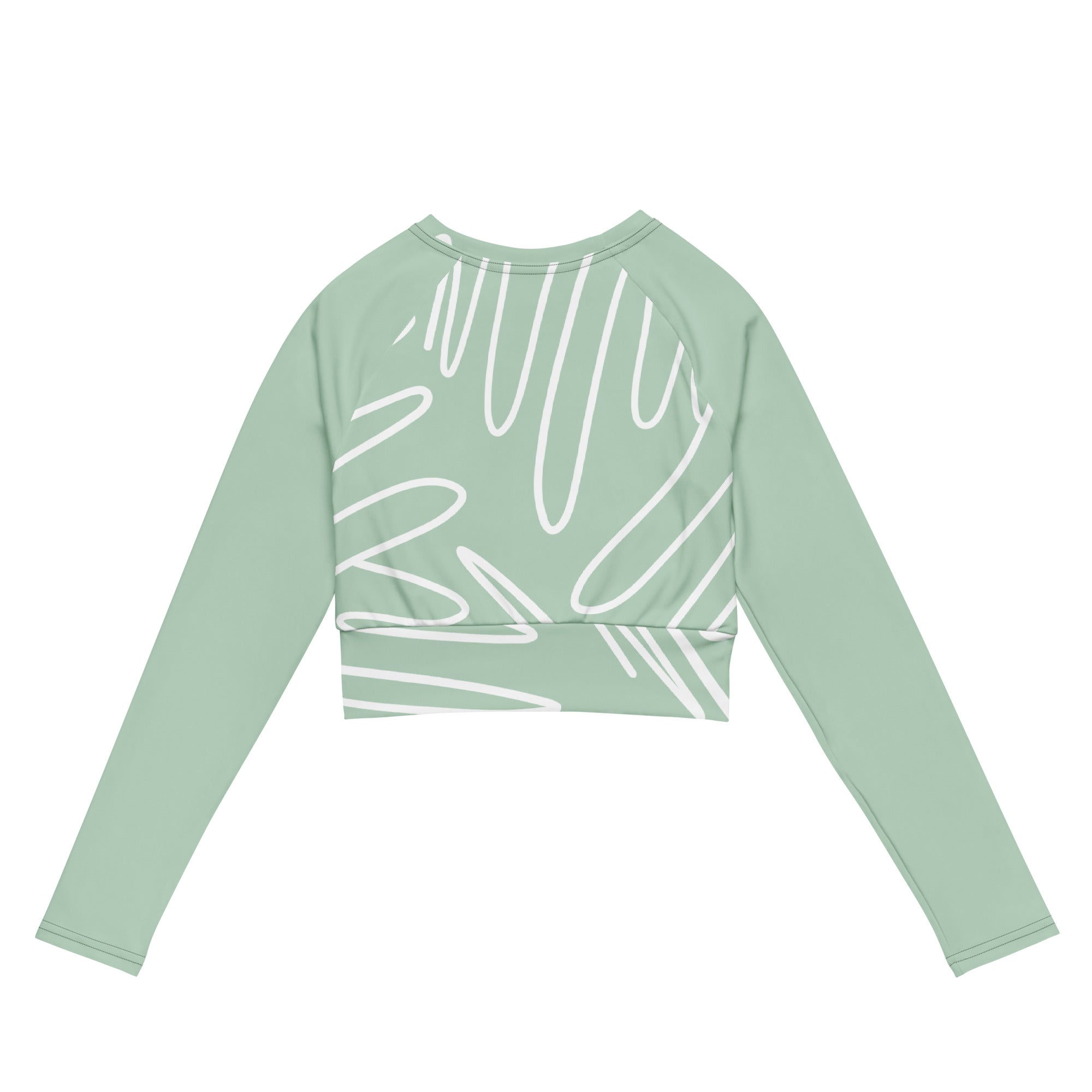 Haut court vert menthe à manches longues, imprimé blanc abstrait, présenté à plat.