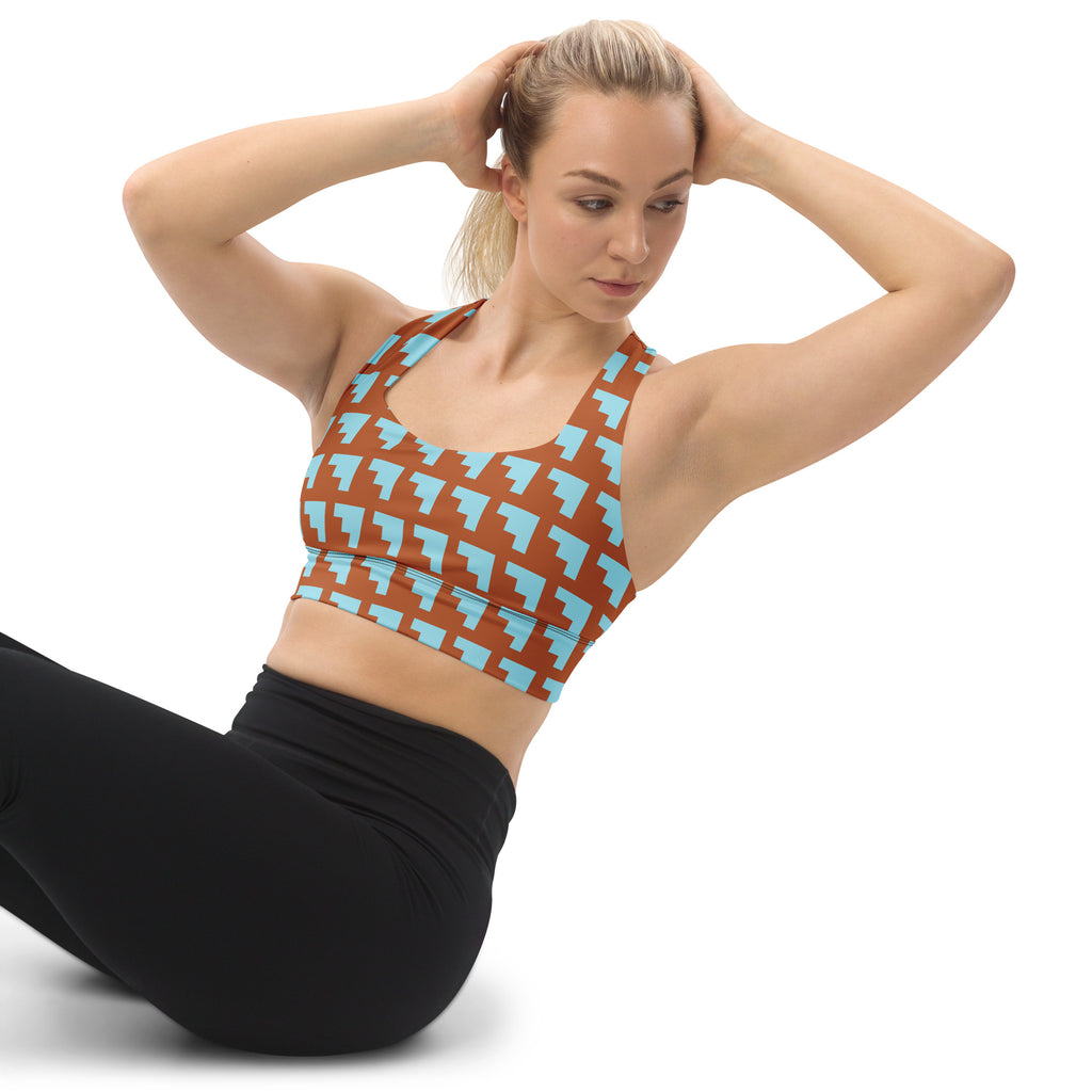 Brassière de sport rembourrée motifs géométriques orange et bleu, bretelles échancrées.