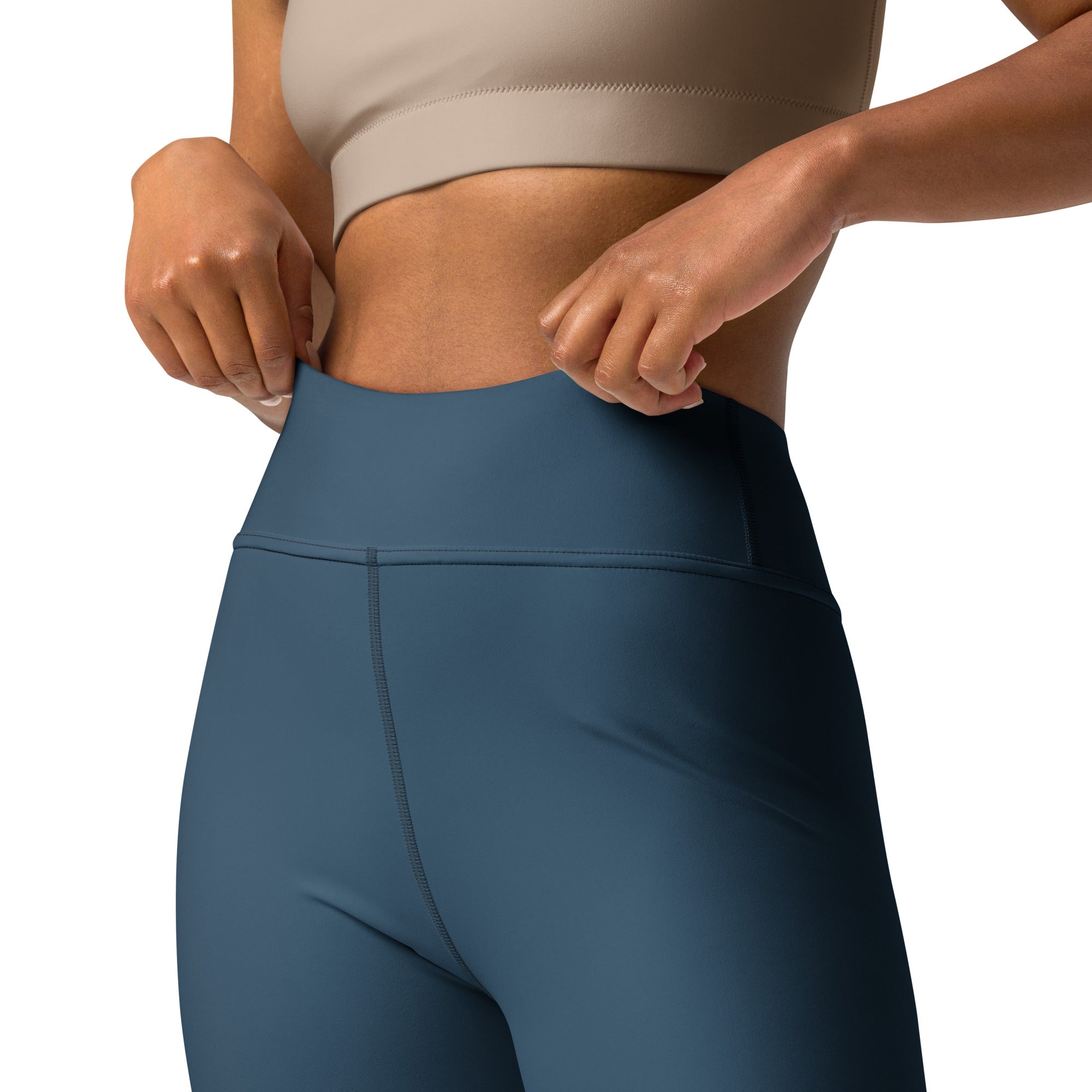Legging de sport bleu foncé taille haute avec ceinture gainante et coutures.