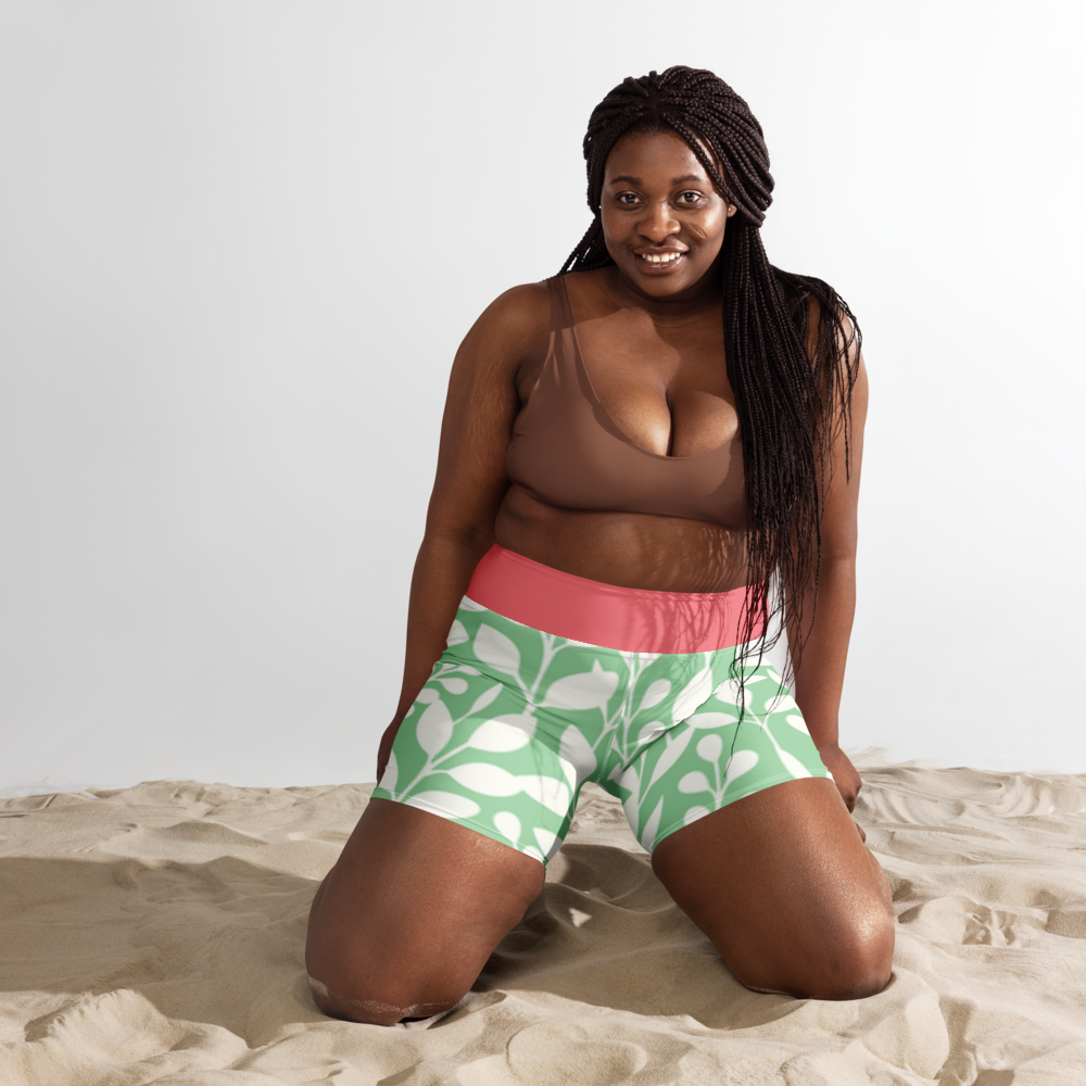 Short de sport vert à motif feuilles et taille rose, logo « GLOWFIT CLUB » en haut