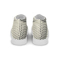 Paires de baskets hautes en toile crème à pois noirs, talon blanc.