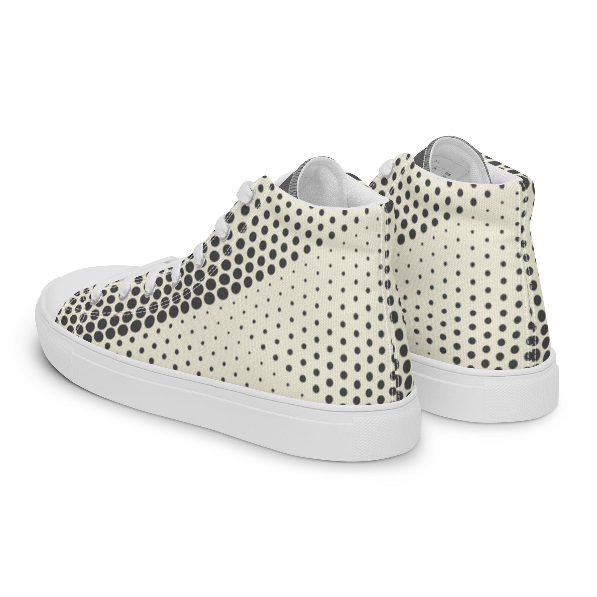 Baskets hautes en toile crème à pois noirs, côté arrière et semelle blanche.